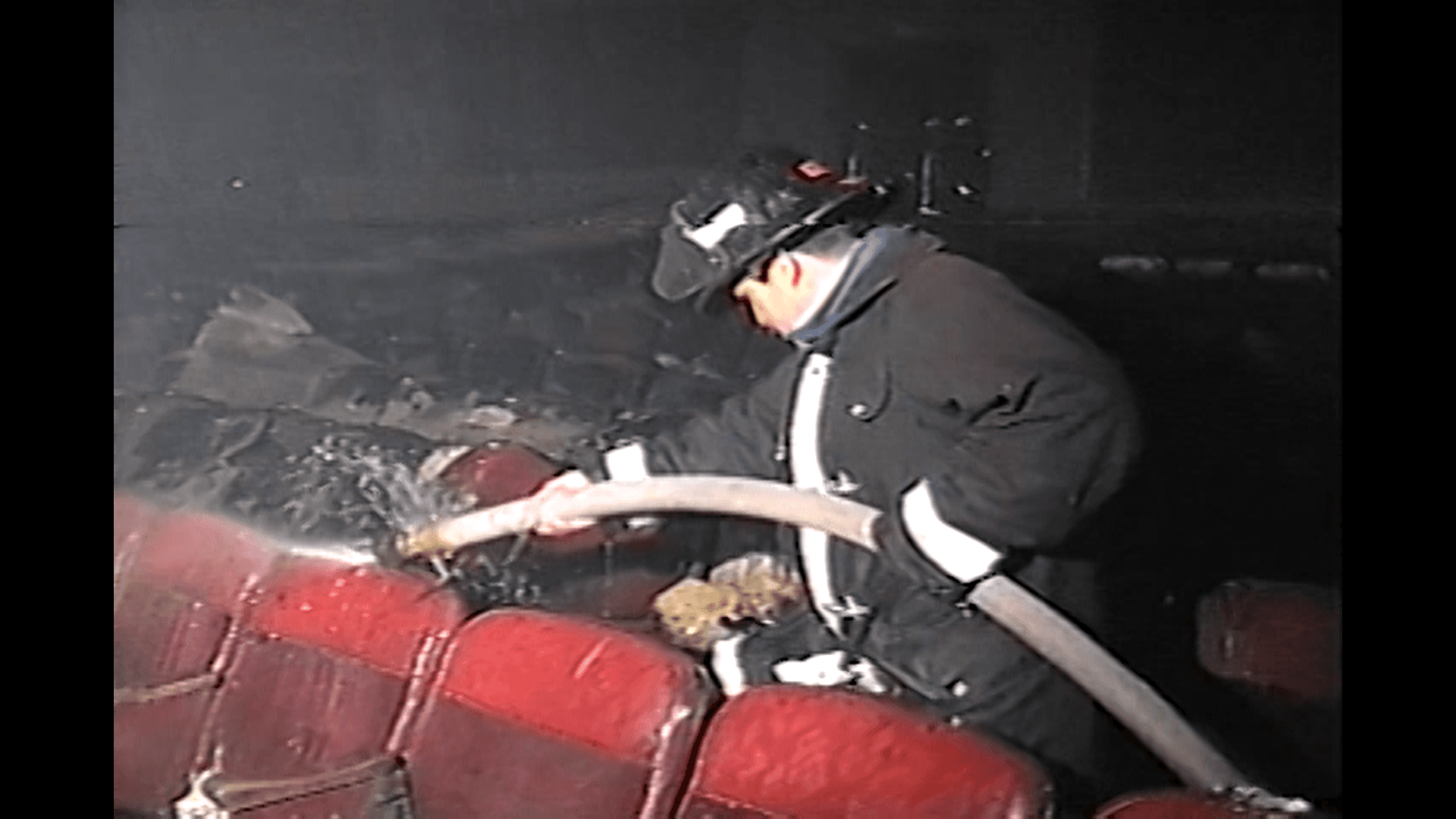 Bombero con manguera entre las butacas